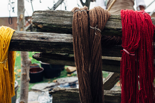 Dyed wool drying on a fence