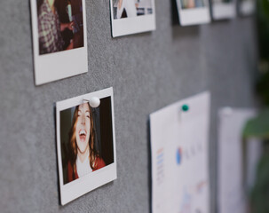 Picture of laughing young woman pinned on grey felt office notice board