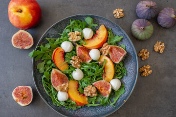 healthy arugula salad with mozzarella cheese and figs