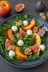 healthy arugula salad with mozzarella cheese and figs