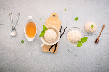 Vanilla ice cream flavor in bowl with vanilla pods setup on concrete background . Summer and Sweet menu concept.