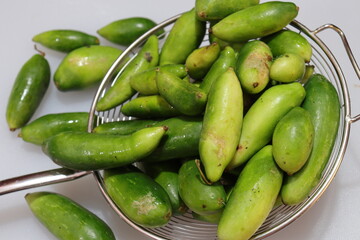Organic Raw green Coccinia grandis or Ivy gourd on a white background