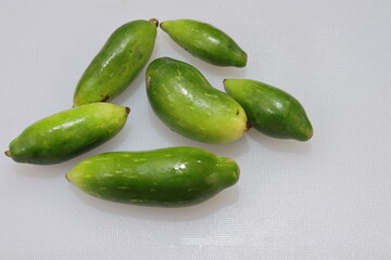 Organic Raw green Coccinia grandis or Ivy gourd on a white background