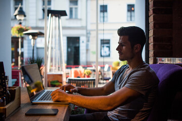 Man using a laptop in a cafe