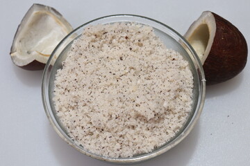 Close up view of dried coconut chips powder on white background in india