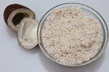 Close up view of dried coconut chips powder on white background in india
