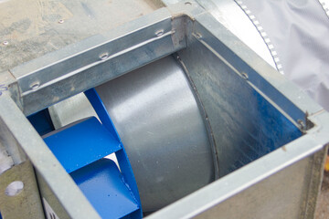 Obraz premium air ducts, a radial fan and a centrifugal engine prepared for installation, foreground and background blurred with bokeh effect