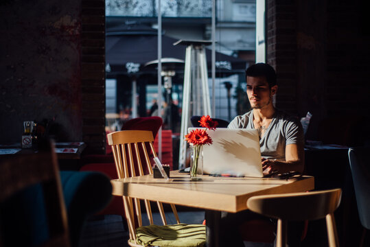 Young businessman sitting and working on pc