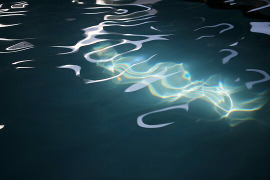An Abstract Patch Of Sunlight Hitting A Pool Of Blue Water