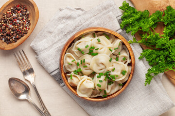 Homemade meat dumplings with onions and parsley- russian pelmeni. Top view