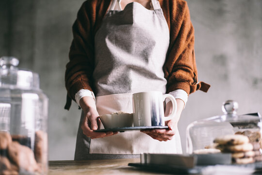 Woman Holding Cookies and Coffee
