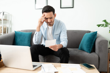 Man looking stressed about his bills