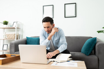 Man working on his laptop from home