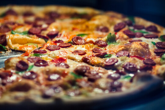 fresh and tasty Italian pizza, cheese, tomatoes, sausage, arugula, vegetables