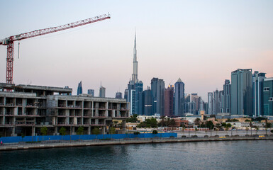View of the Dubai city skyline at "Dubai Water Canal". "Business Bay" district. Tallest building in the world "Burj Khalifa" can be seen in the picture.