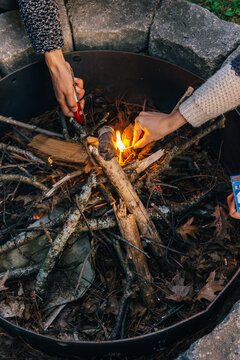 Friends lighting a fire