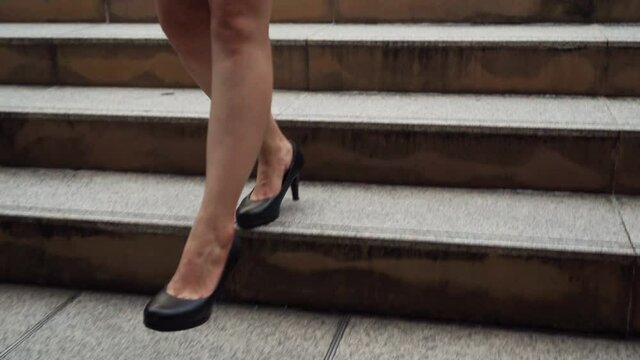 Business Woman With High Heel Shoes Walking Down On The Stairs In The City