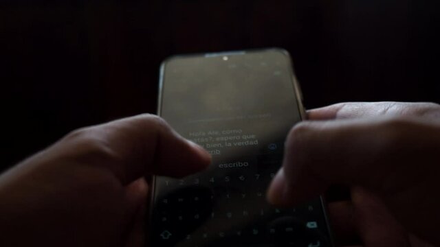 Hands of a man texting on the phone