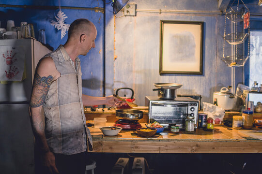 A tattooed artist in his ramshackle home.