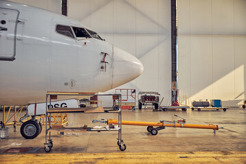 Passenger aircraft in the hangar on the service