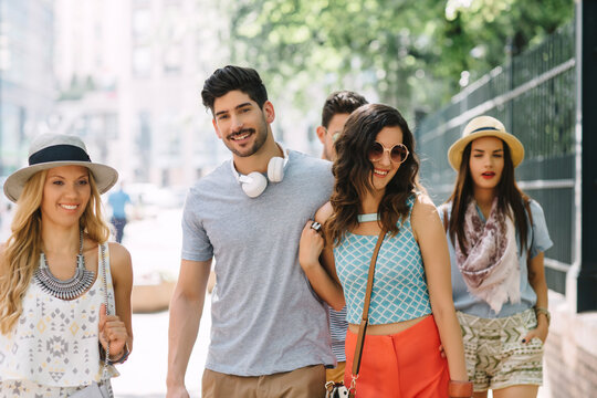 Couple With Friends Walking on the Street