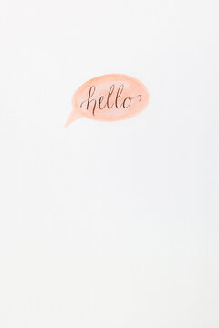 the word ""hello"" in calligraphy on a watercolor speech bubble