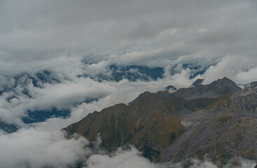 The mountain landscape with clouds around in Dagu glacier park in Sichuan, China.