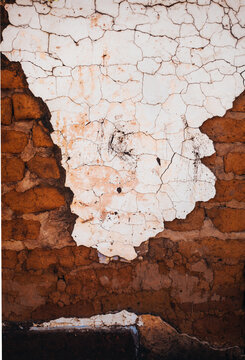 White Render Coming Off Old Brick Wall