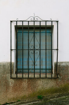 Window with shutters and security bars