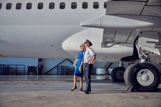 Captain With Air Hostess Enjoying Good Weather In The Airport