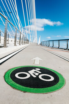 Bright painted bycicle sign and arrow painted on a bike lane on a bridge