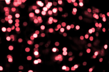 Blurry colored Christmas holiday lights on a black background.