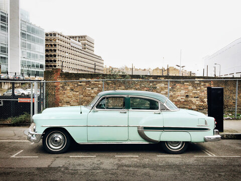 An old american car parked on a street