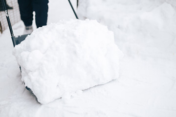 Fototapeta na wymiar Snow removal with shovel
