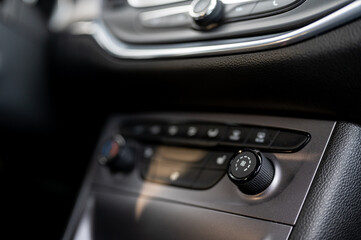 Obraz na płótnie Canvas Modern car interior: steering wheel, gearshift lever, multimedia system. The air conditioning button inside a car. Car interior