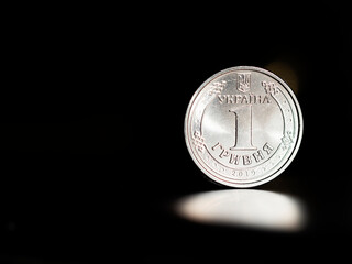 Ukrainian coin in denomination of 1 hryvnia on a black background