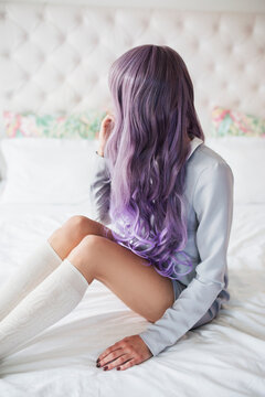 Fashionable young woman with purple hair