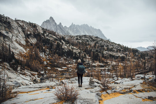 Backpacker against rugged mountainous landscape in Autumn