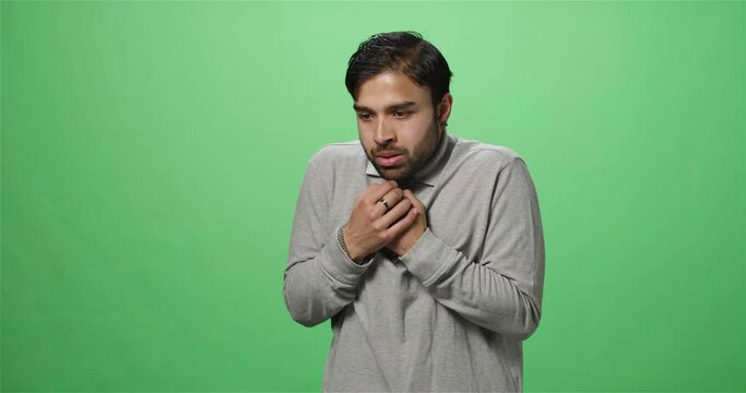 Terrified man looking around, green screen