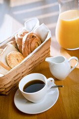 bread in the basket with coffee and juice