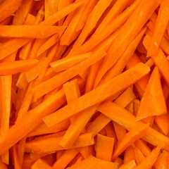 Coarsely chopped orange carrot. The process of cooking pilaf. Fresh natural vegetables background.