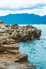 Beauty panorama pure blue lazure empty sea skyline, vivid brown gray rock shabby cliff, water splash, cumulus cloud sky, mountain island background. Concept sea tourism after pandemic, power in nature
