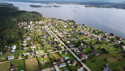 Top view of suburban cottages and houses. Near green summer fields © Payllik