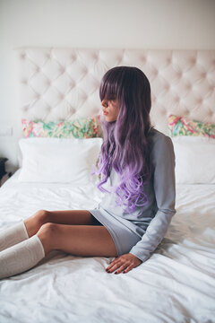 Fashionable young woman with purple hair