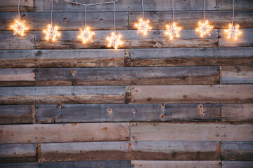 Decorative wall with snow flake lights hanging from above