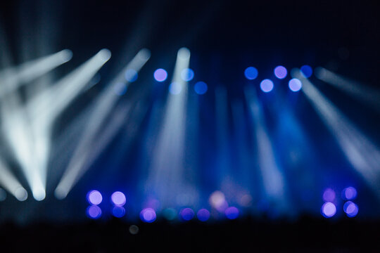 Blue and white blurred laser lights at an indoor gig
