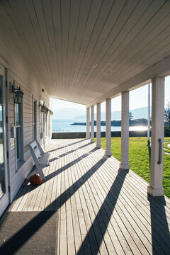 Front Porch Drenched In Sunlight And Shadow Near Seashore