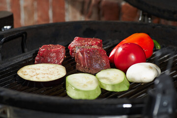 Fresh meat and vegetables grilled at a homemade weekend barbecue. Cooking concept, dark kitchen