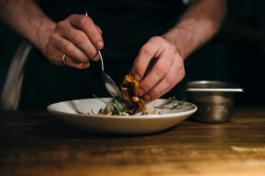 Man's hands cooking delicious dinner with mushrooms
