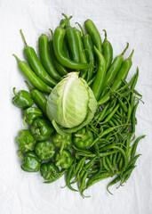Four types of green vegetables shot in a group with white background.